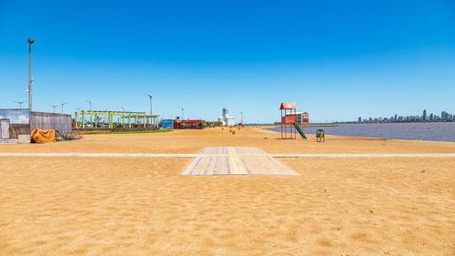 Scenic view of beach against clear blue sky