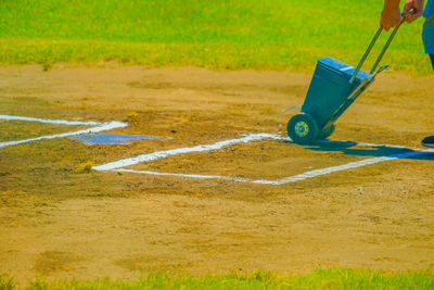 Low section of man playing soccer on field