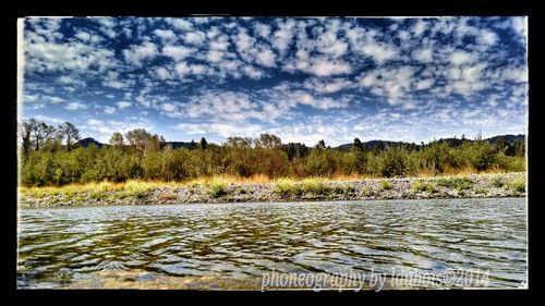 Scenic view of lake against cloudy sky