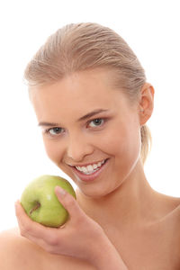 Close-up portrait of a smiling young woman against white background