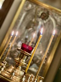 Close-up of lit candles in temple