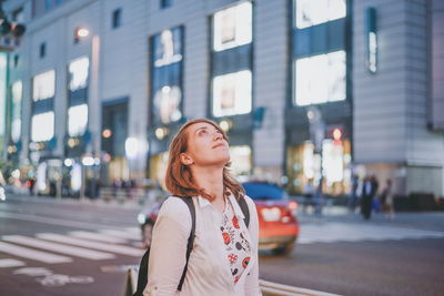 Woman looking at city street