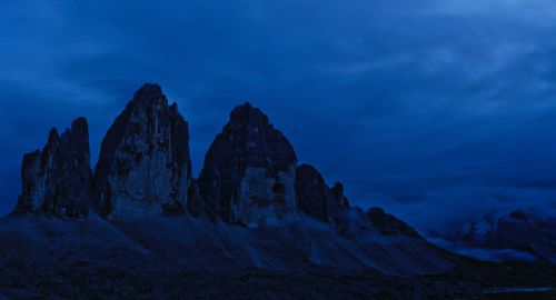 Rock formations against sky at dusk