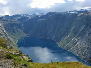 Scenic view of mountains against cloudy sky