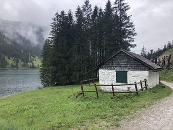 Gazebo by lake against sky