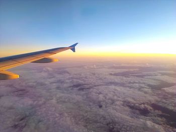Aerial view of airplane wing against sky