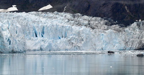 Ancient glacier and foggy dramatic sky in alaska ocean bay