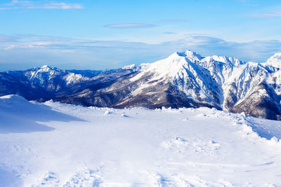 Scenic view of snowcapped mountains against sky