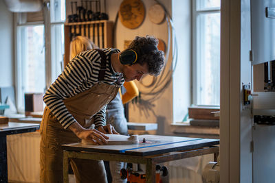 Side view of man working at home