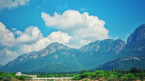 Scenic view of mountains against cloudy sky