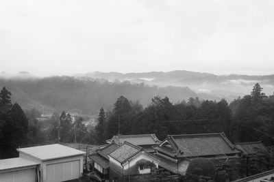 High angle view of houses and trees against sky