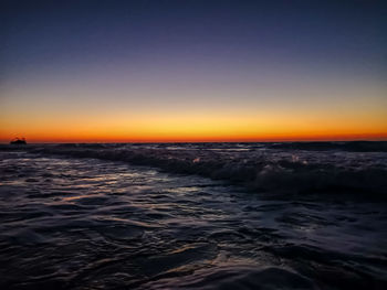 Scenic view of sea against clear sky during sunset