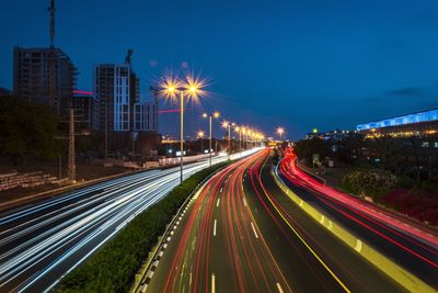 Light trails on road against sky at night