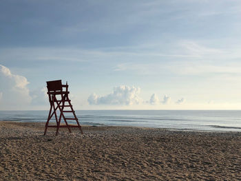 Lifeguard hut on beach against sky