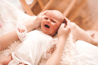 Portrait of cute baby girl sleeping on bed at home