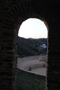 Arch bridge against sky seen through archway