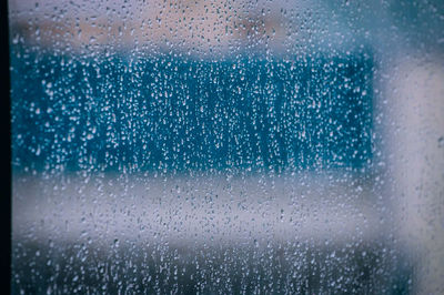 Full frame shot of wet glass window in rainy season