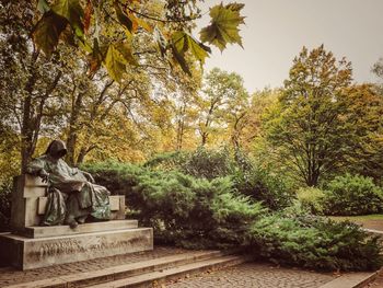 Statue amidst trees during autumn