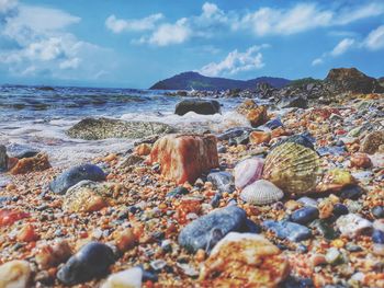 Pebbles on beach against sky