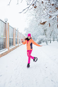 Winter workout, exercising in cold weather. winter fitness trening kangoo jumps. sporty woman in