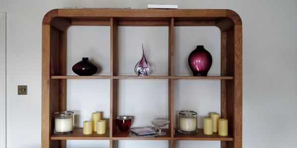 Close-up of bottles on shelf against wall