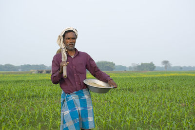 Full length of man standing in farm