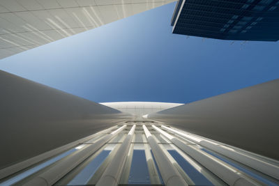 Low angle view of modern building against clear blue sky