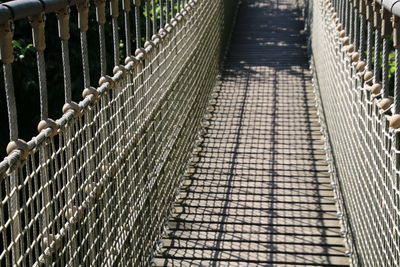 Empty footbridge on sunny day
