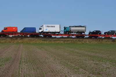 Train on field against clear sky