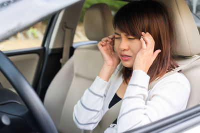 Portrait of woman sitting in car