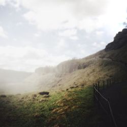 Scenic view of landscape against cloudy sky