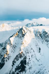 Scenic view of snow covered mountains against sky