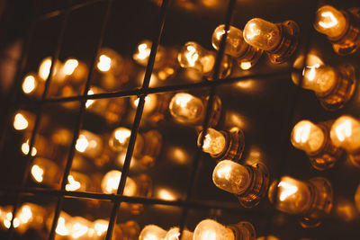 Low angle view of illuminated light bulbs