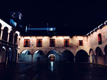 Illuminated building against sky at night