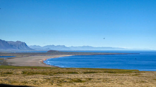 Scenic view of sea against clear blue sky at raudfeldsgja gorge