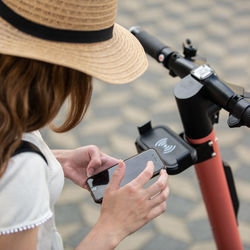 Midsection of woman using mobile phone