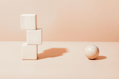  natural wooden cubes and ball, neutral beige geometric details scene for product presentation.