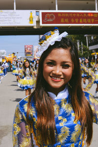 Portrait of smiling young woman standing outdoors