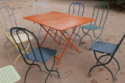 High angle view of colorful empty chairs arranged by table