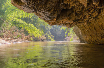 Scenic view of river flowing through cave