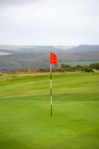 Lifeguard hut on golf course against sky