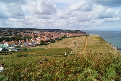 Panoramic view of townscape by sea against sky