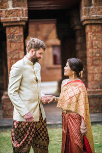 Young couple in front of historic building