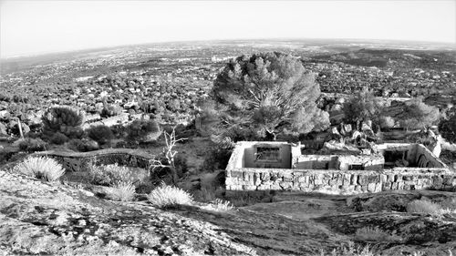 Scenic view of townscape and mountains against sky