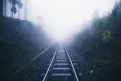 View of railroad tracks on foggy day