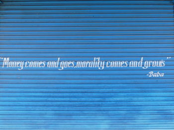 Close-up of text on blue wall