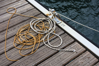 Tangled rope tied on cleat at pier