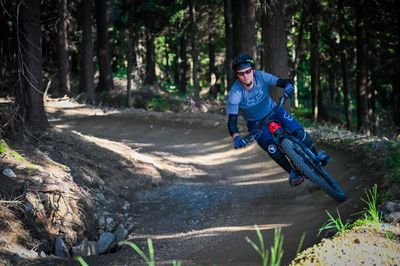 Man riding bicycle in forest