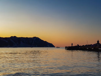 Scenic view of sea against orange sky