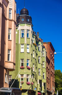 Low angle view of buildings against blue sky